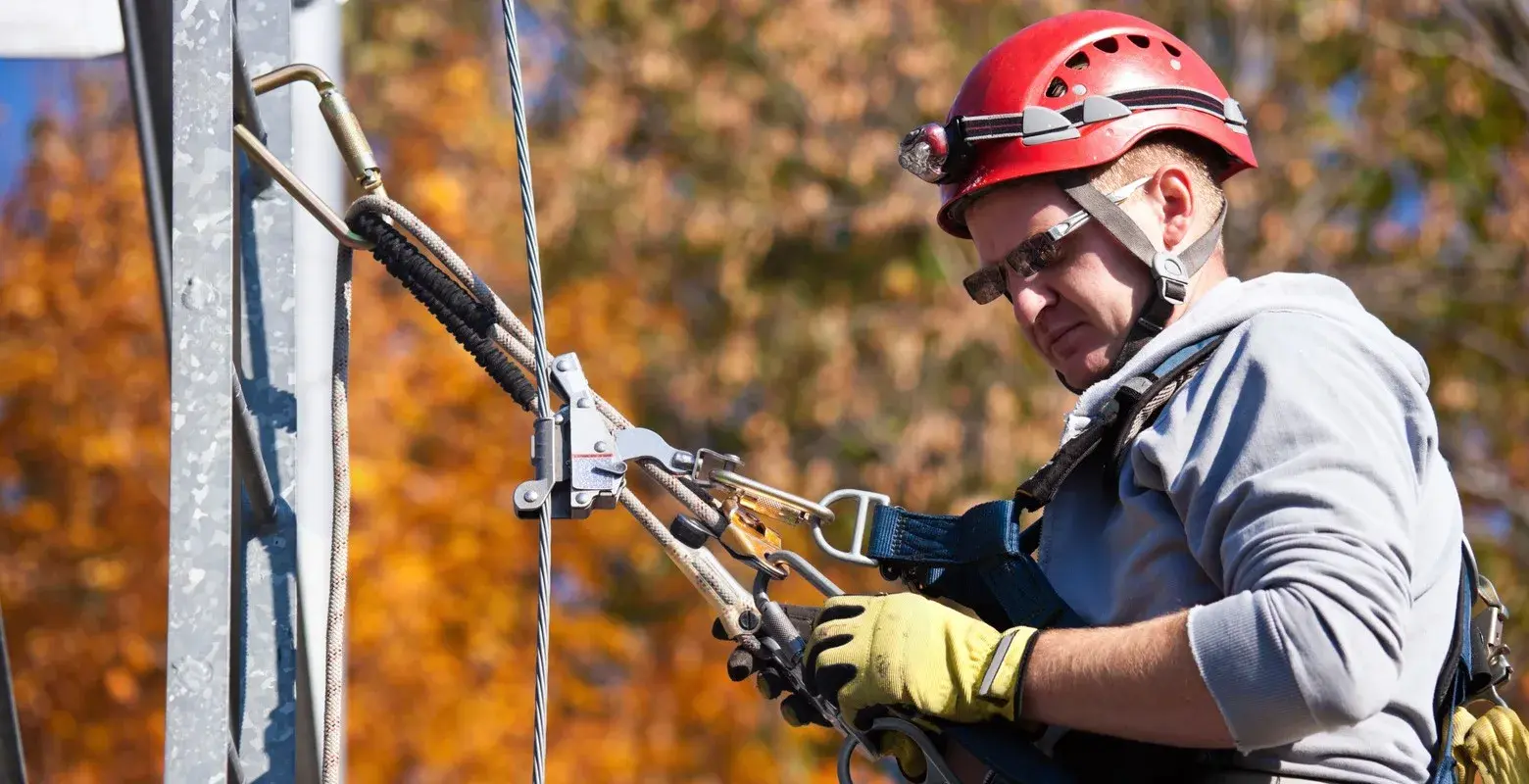 Climber ascending cellular tower